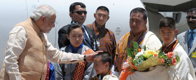 Prime Minister, Shri Narendra Modi being welcomed by the children, on his arrival at Paro International Airport, in Bhutan