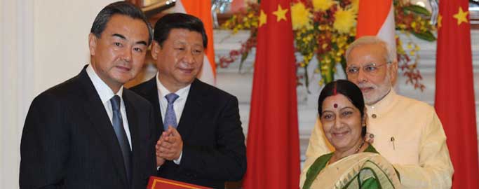 The Prime Minister, Narendra Modi and the Chinese President, Xi Jinping witnessing the signing of an MoU between the Ministry of External Affairs Minister, Sushma Swaraj and Minister of Foreign Affairs of the People's Republic of China, Wang Yi on opening a New Route for Indian Pilgrimage (Kailash Mansarovar Yatra) to the Tibet Autonomous Region of the People's Republic of China, in New Delhi.