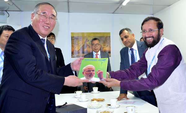 The Minister of State for Environment, Forest and Climate Change (Independent Charge), Prakash Javadekar presenting the book on Climate Change authored by the Prime Minister, Narendra Modi, to the Vice Chairman, NDRC, China, Xie Zhenhua, at UN Climate Change Conference, in Lima, Peru on December 08, 2014.