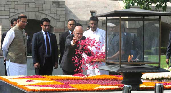 The President of the Islamic Republic of Afghanistan, Dr. Mohammad Ashraf Ghani paying floral tributes at the Samadhi of Mahatma Gandhi, at Rajghat, in Delhi on April 28, 2015. The Minister of State for Finance, Jayant Sinha is also seen.