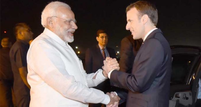 Modi breaks protocol, receives French President at airport