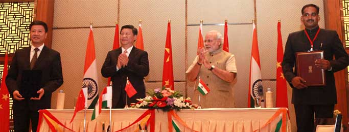 The Prime Minister, Narendra Modi and the Chinese President, Xi Jinping witnessing the signing of an MoU between the cities of Guangzhou, China and Ahmedabad, Gujarat, India for closer cooperation between the local authorities of the two cities, which will facilitate engagements in the fields of economy and trade, environment protection, public policy, education, health, science and technology, tourism and culture, at Hyatt Hotel, Ahmedabad on September 17, 2014.